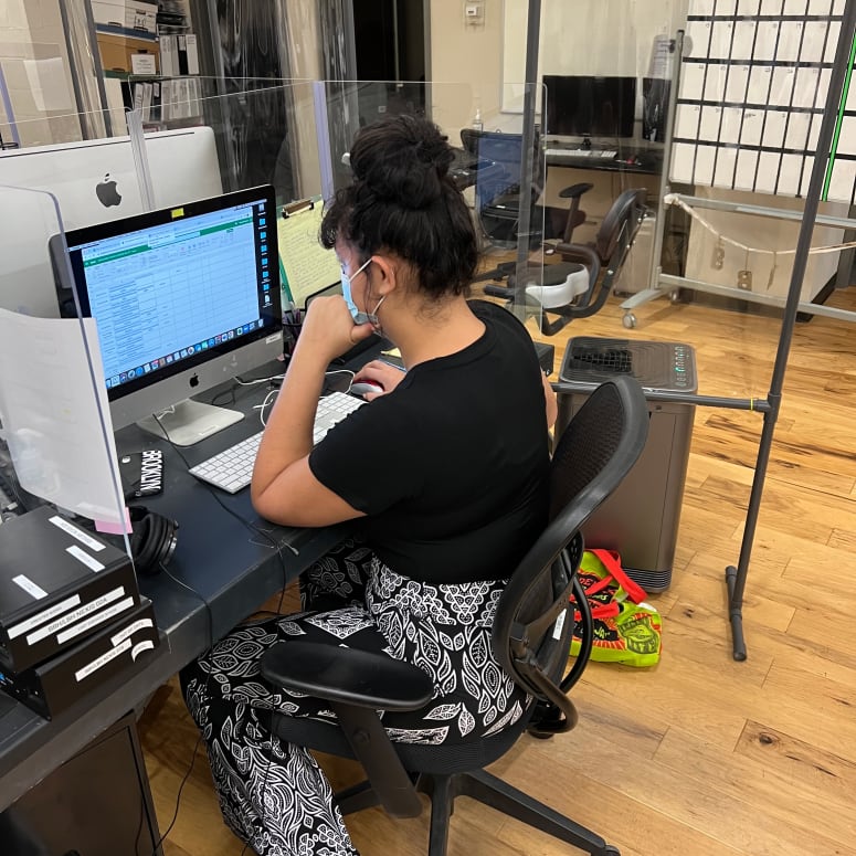 A student working at a desktop computer.