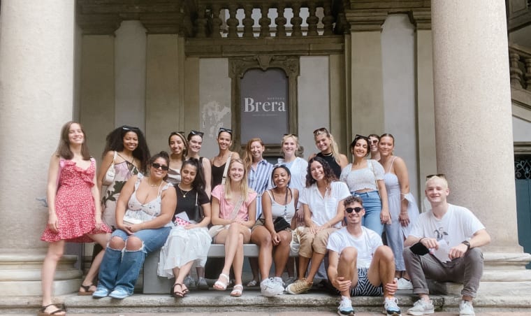 A group of interns outside of a building.