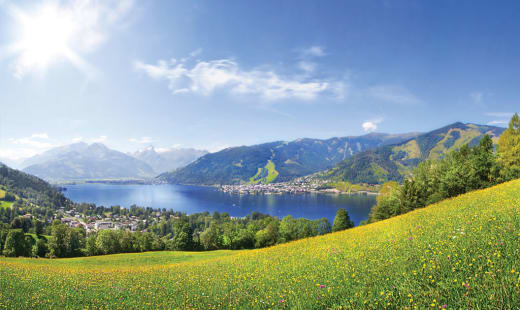 A lake surrounded by green fields.